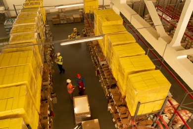 Image of Manager and workers at warehouse, above view. Logistics center