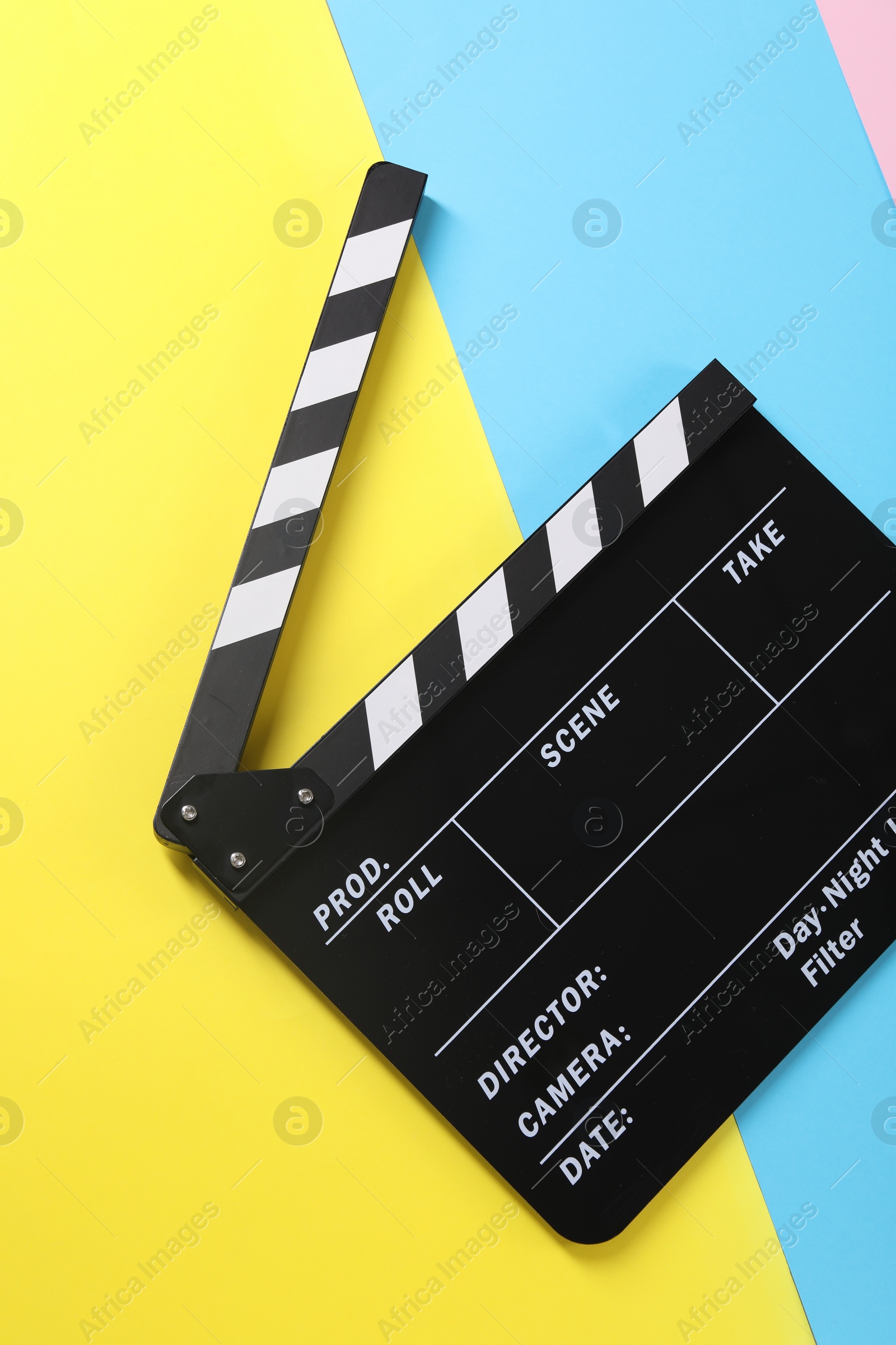 Photo of Clapperboard on color background, top view. Film industry