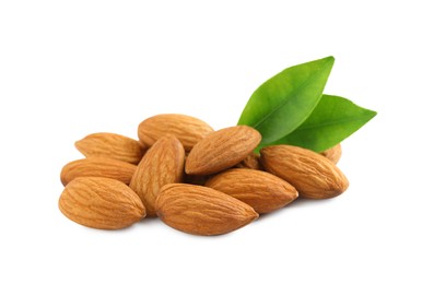 Photo of Organic almond nuts and green leaves on white background. Healthy snack