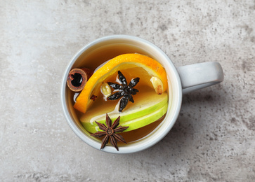 Photo of Aromatic white mulled wine on light grey table, top view