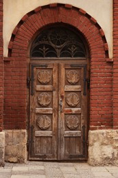 Photo of Entrance of house with beautiful arched wooden door