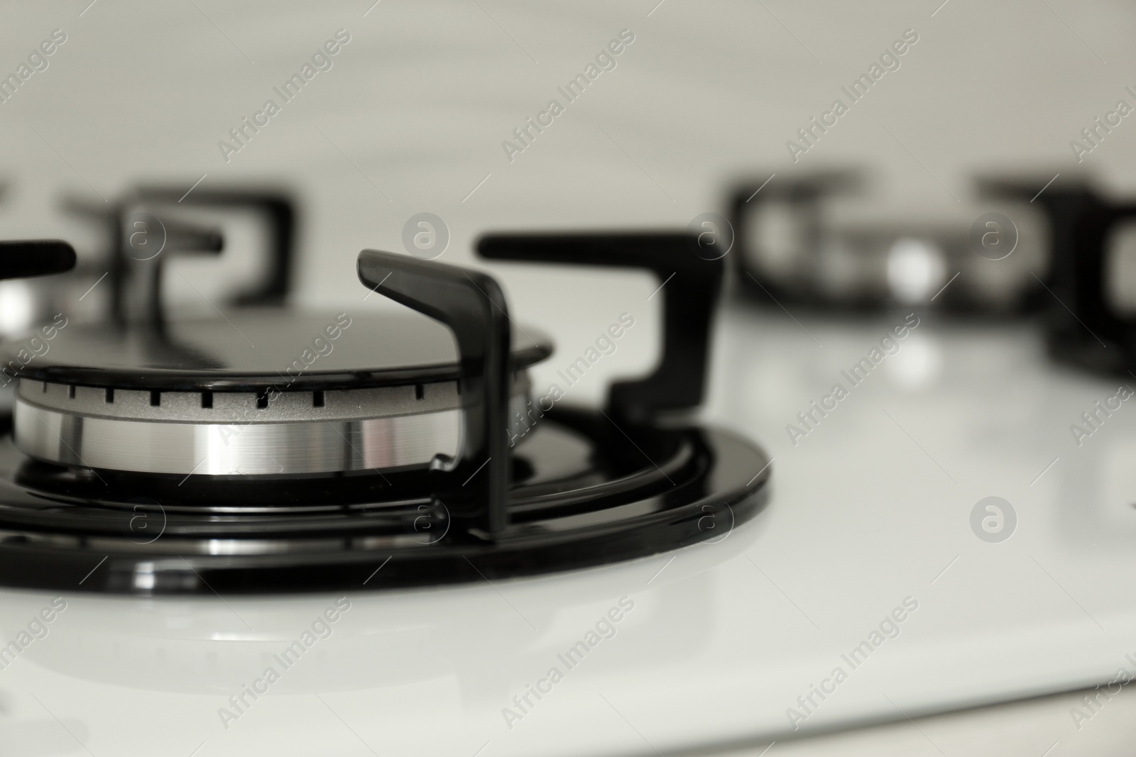 Photo of Modern built-in gas cooktop, closeup with space for text. Kitchen appliance