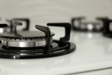 Modern built-in gas cooktop, closeup with space for text. Kitchen appliance