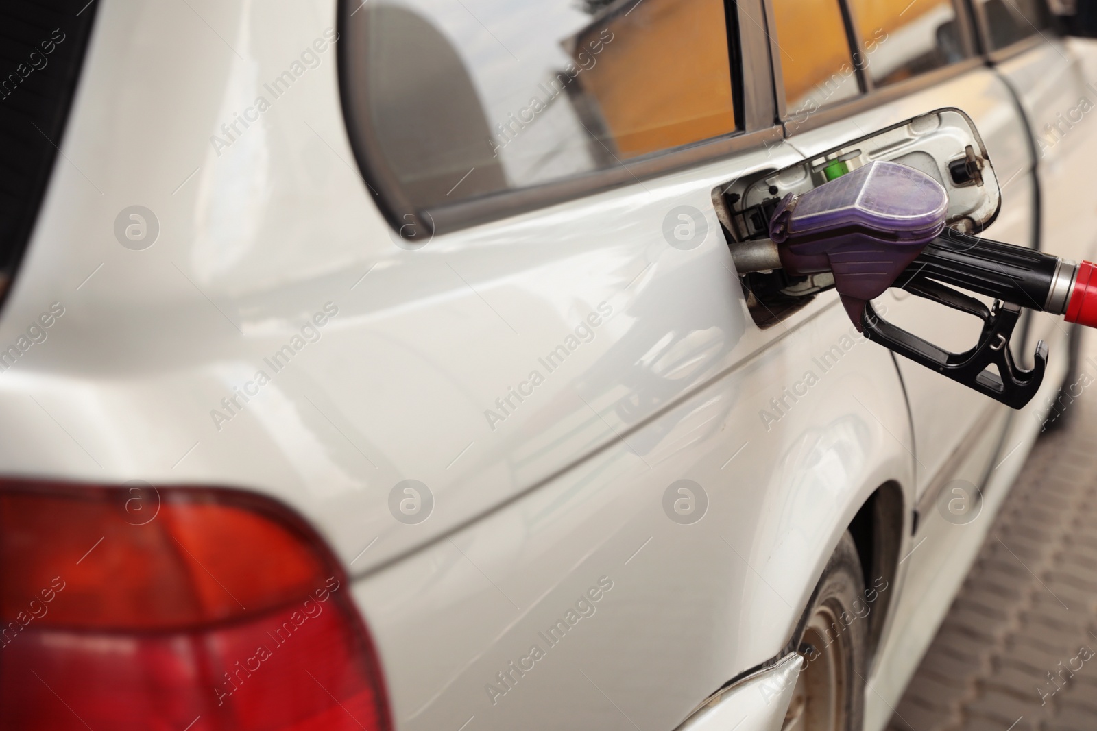 Photo of Refueling modern car at gas filling station, closeup