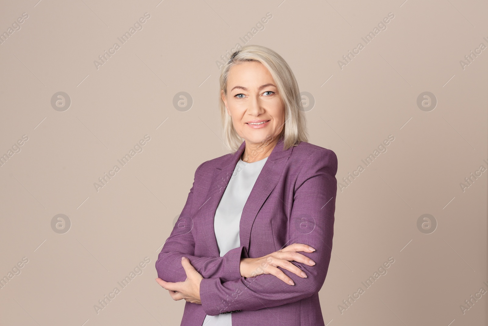 Photo of Portrait of beautiful mature woman on beige background