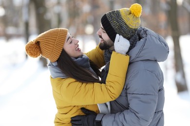 Happy young couple having fun outdoors on winter day