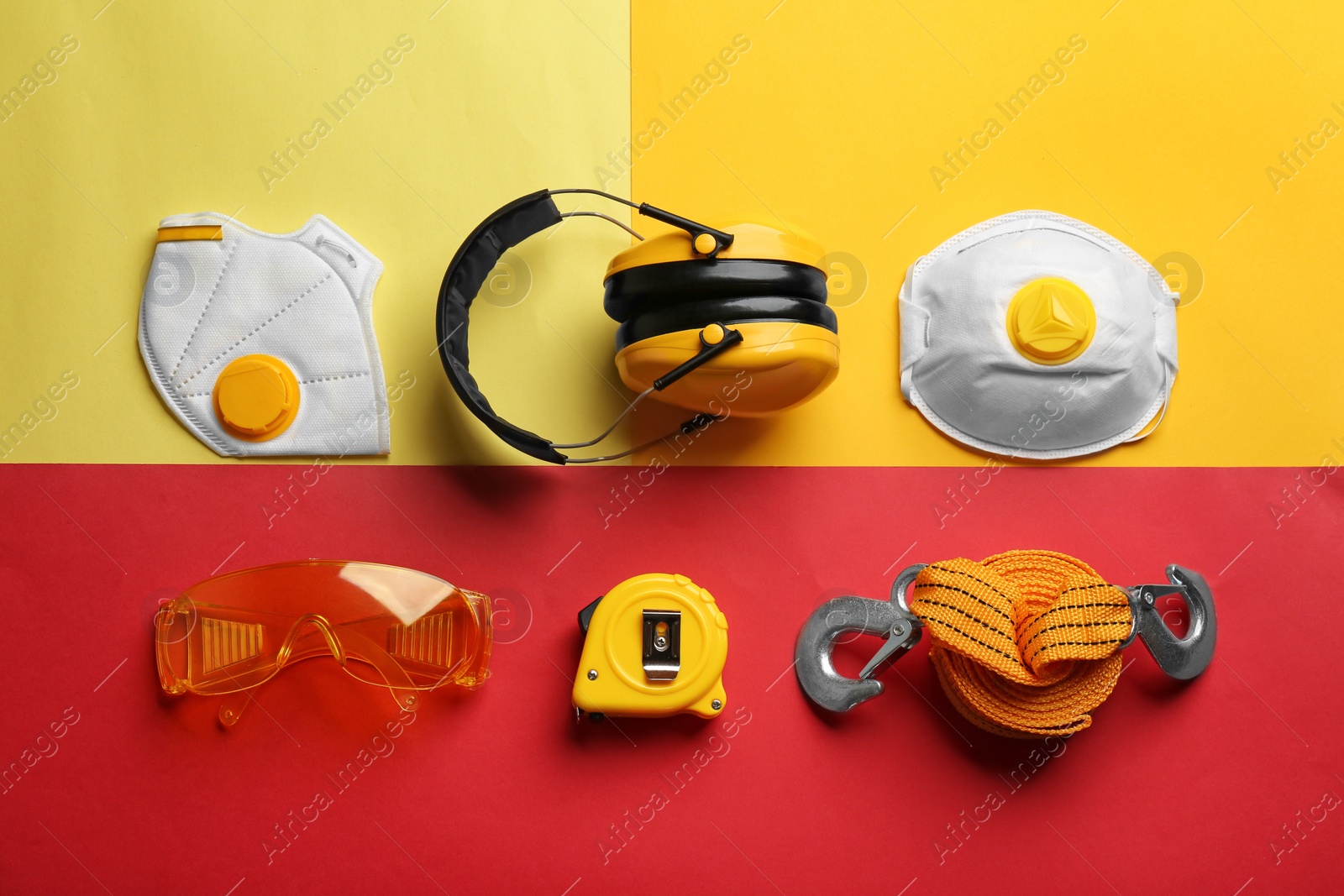 Photo of Flat lay composition with safety equipment on color background