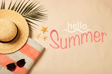 Image of Hello Summer. Beach towel, sunglasses, hat, palm leaf and starfishes on sand, flat lay