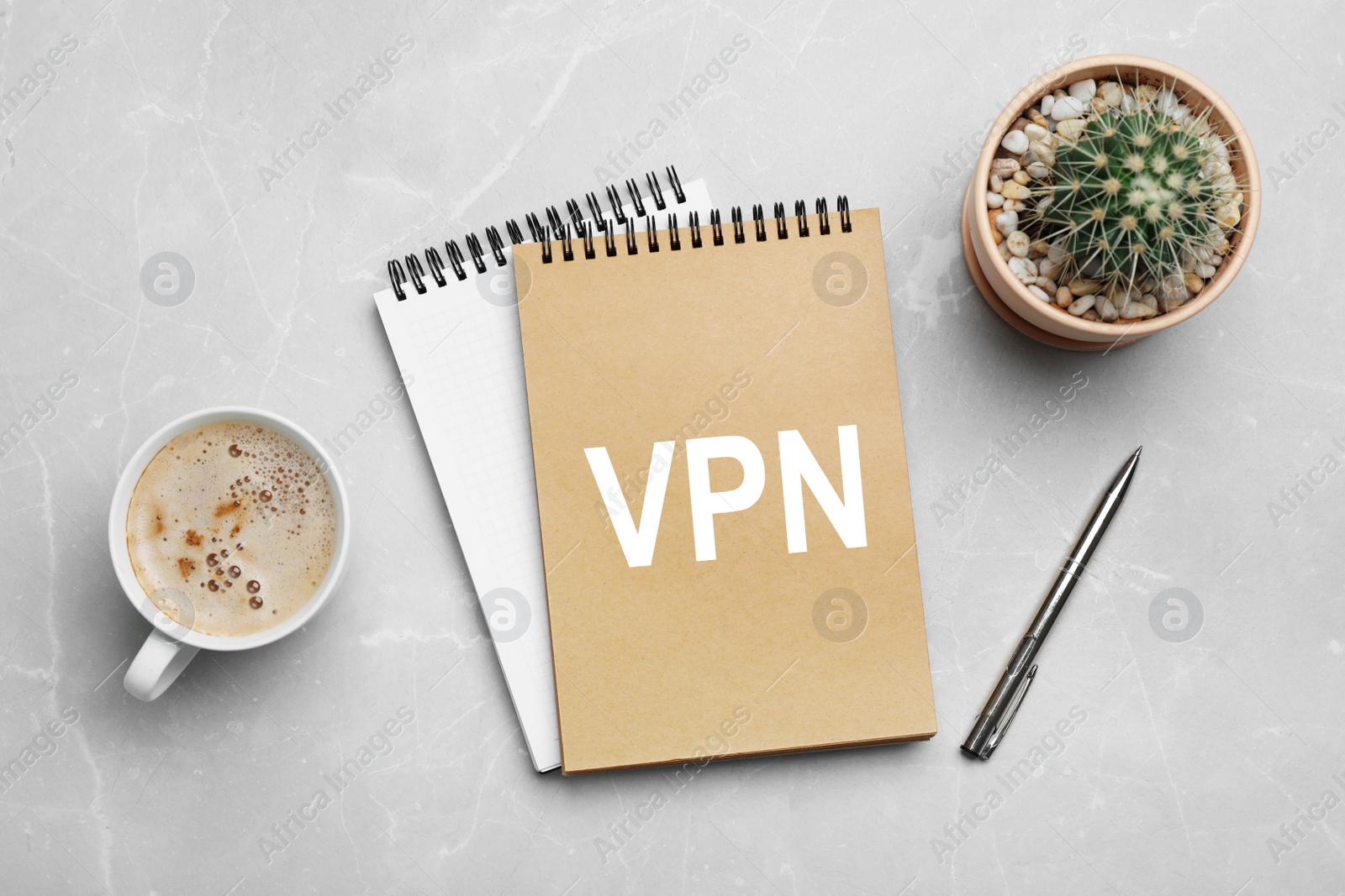 Image of Notebook with acronym VPN on light grey marble table, flat lay. Secure network connection