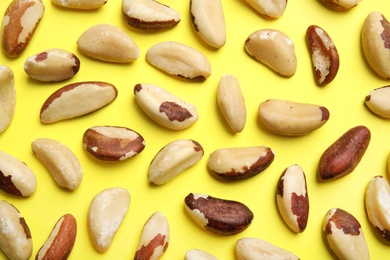 Flat lay composition with Brazil nuts on color background