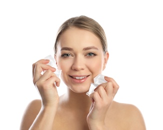 Photo of Young woman with ice cubes on white background. Skin care