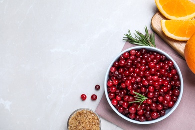 Flat lay composition with fresh ripe cranberries on light table. Space for text