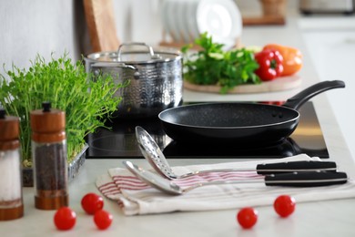 Photo of Countertop with different cooking utensils and vegetables in kitchen