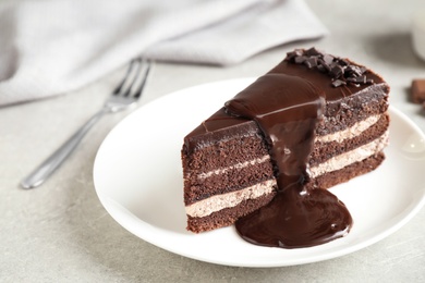 Delicious fresh chocolate cake on light table, closeup