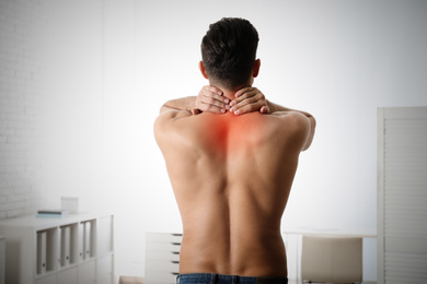 Image of Man suffering from pain in neck at clinic 