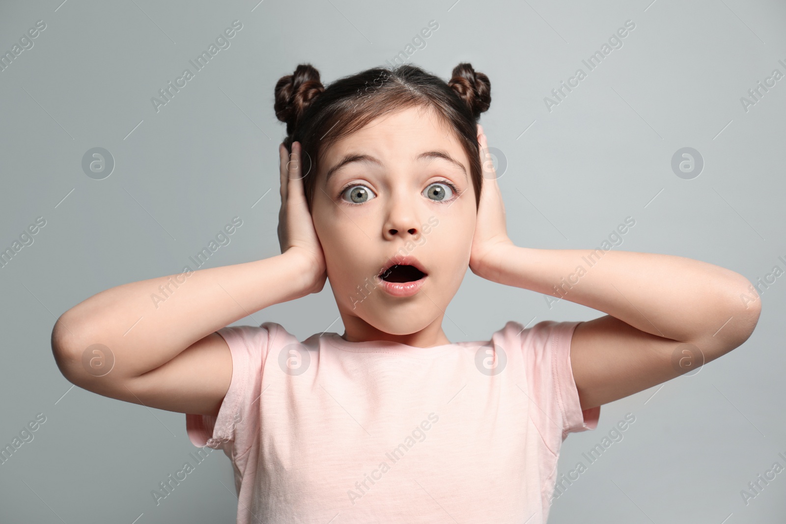 Photo of Little girl feeling fear on grey background