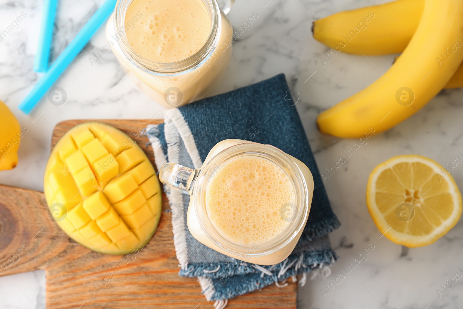 Photo of Mason jars with healthy detox smoothie and ingredients on table, top view