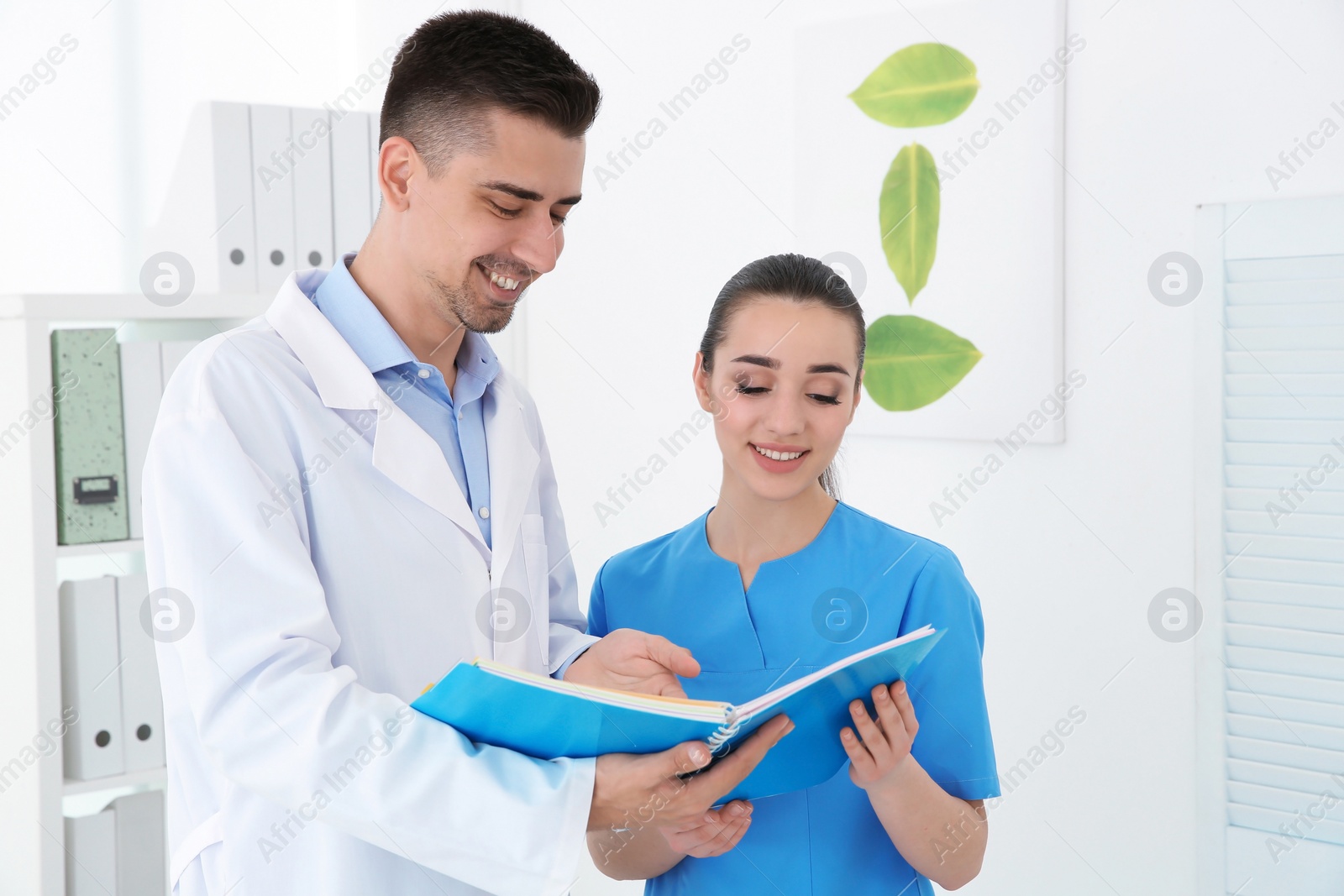 Photo of Young female receptionist and doctor working in hospital