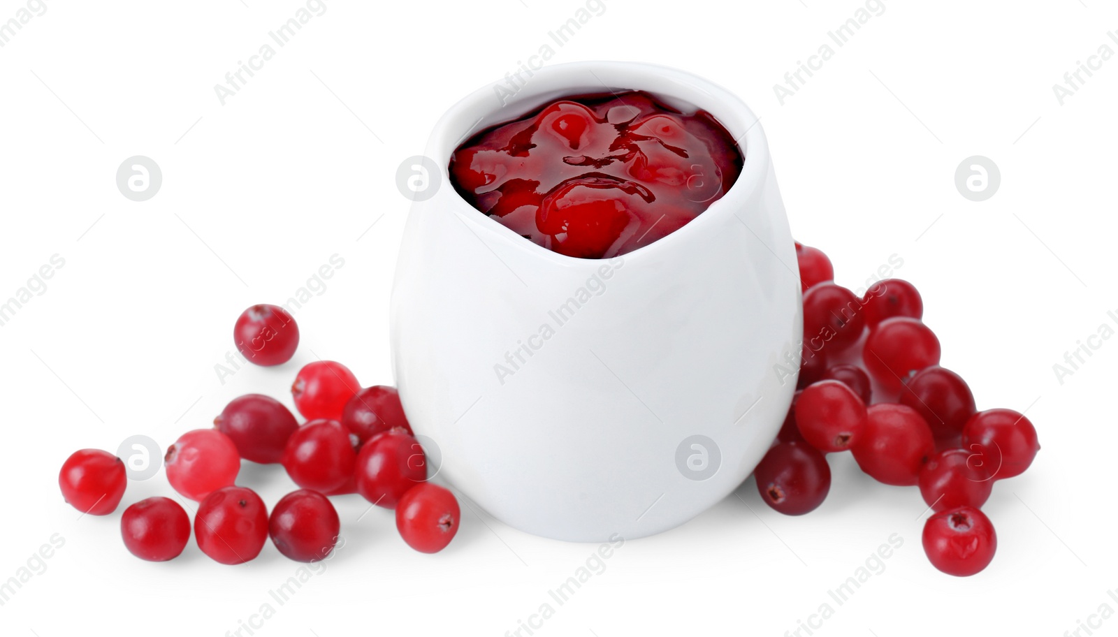 Photo of Cranberry sauce in pitcher and fresh berries isolated on white