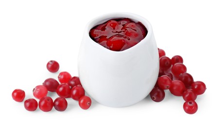 Photo of Cranberry sauce in pitcher and fresh berries isolated on white