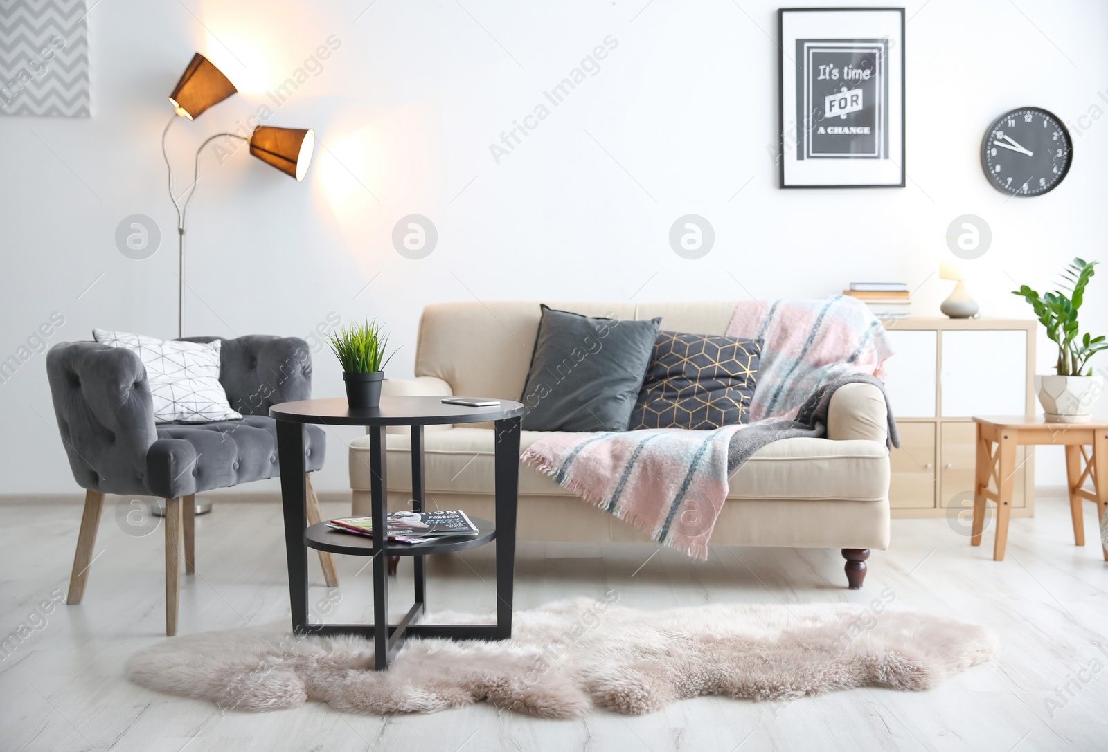 Photo of Stylish living room interior with comfortable sofa, armchair and table