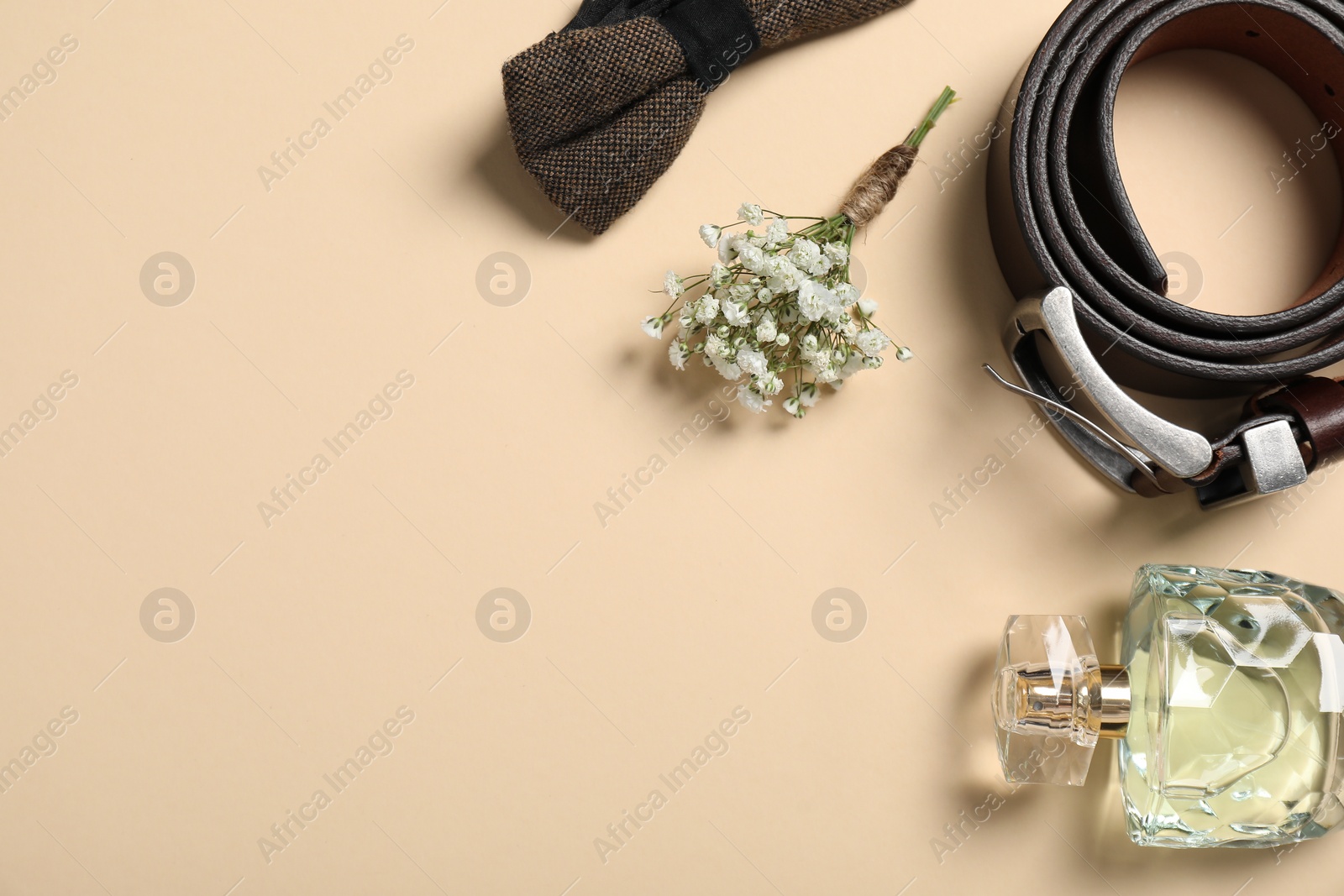 Photo of Wedding stuff. Flat lay composition with stylish boutonniere on beige background, space for text
