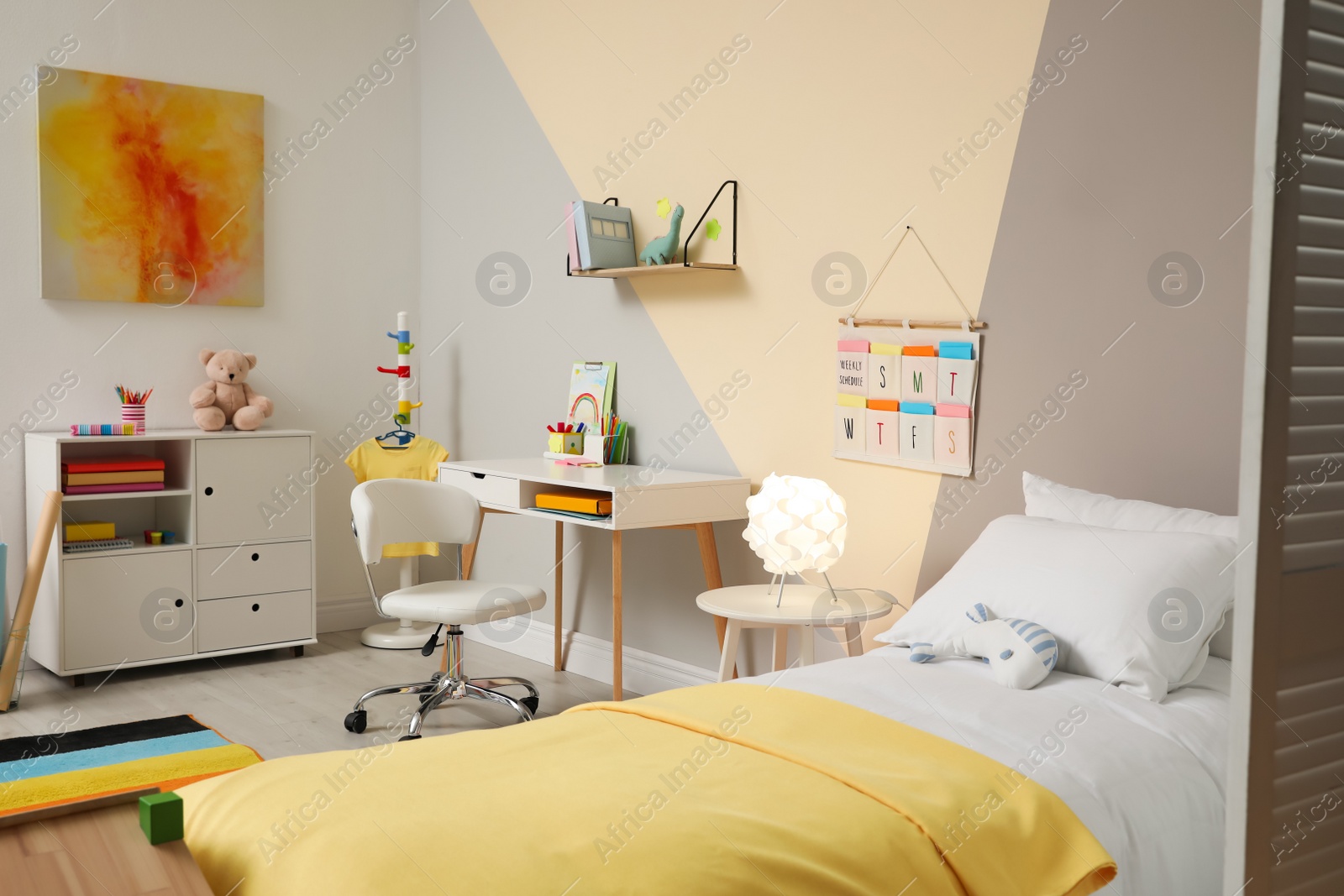 Photo of Stylish child room interior with comfortable bed and desk