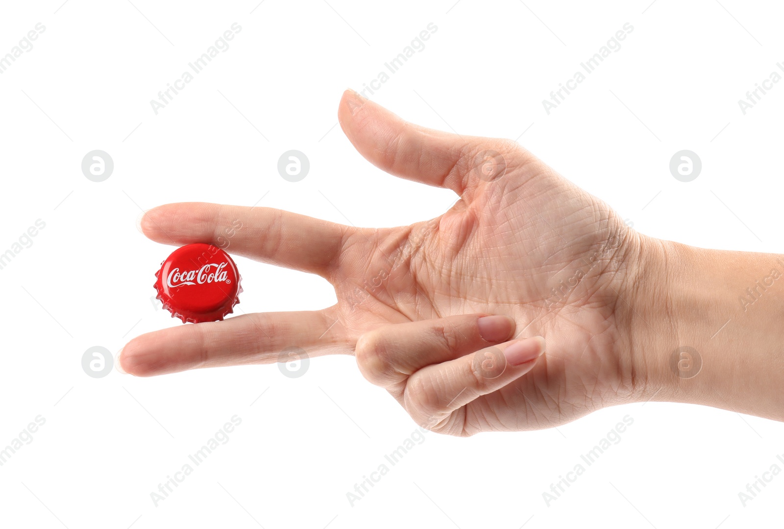 Photo of MYKOLAIV, UKRAINE - NOVEMBER 15, 2018: Woman holding Coca Cola lid on white background