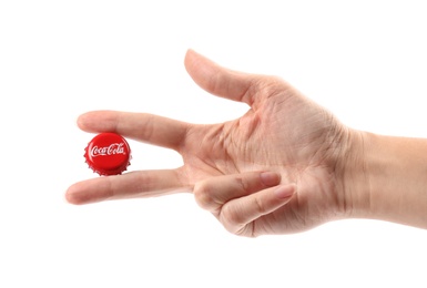 MYKOLAIV, UKRAINE - NOVEMBER 15, 2018: Woman holding Coca Cola lid on white background