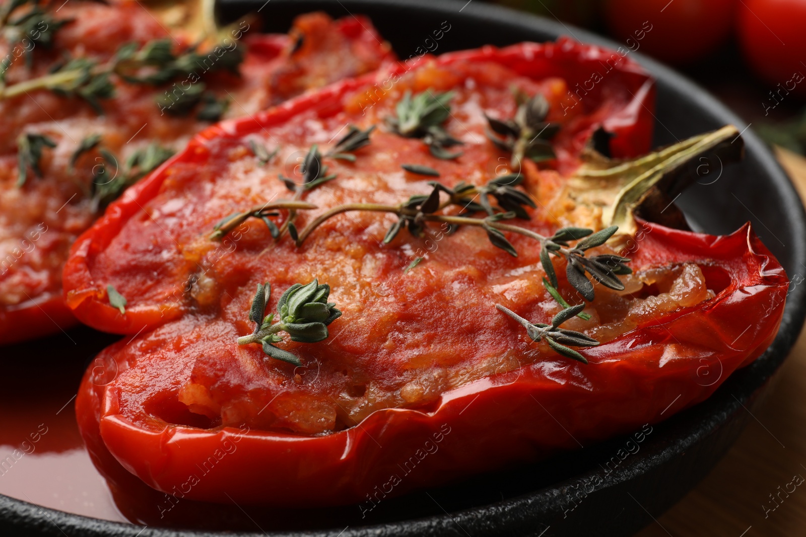 Photo of Tasty stuffed peppers in dish on table, closeup