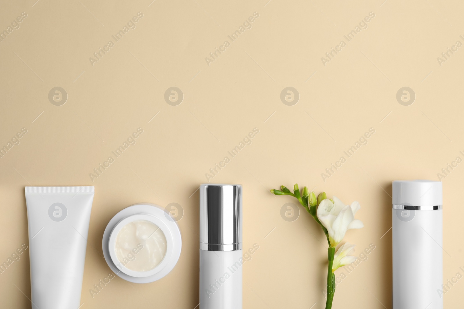 Photo of Set of luxury cosmetic products on beige background, flat lay. Space for text