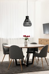 Photo of Stylish dining room interior with table and chairs