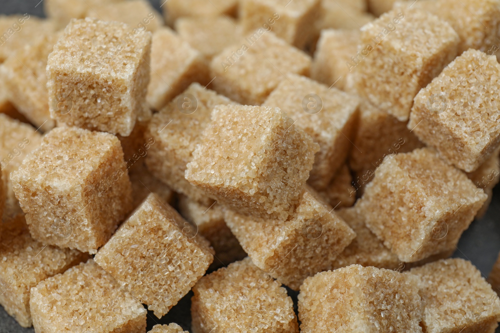 Photo of Brown sugar cubes as background, closeup view