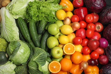 Photo of Fresh ripe fruits and vegetables as background, top view