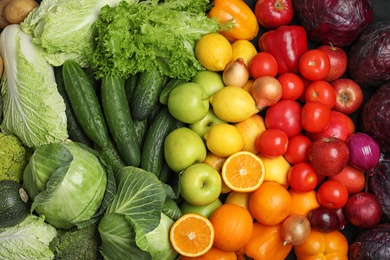 Fresh ripe fruits and vegetables as background, top view