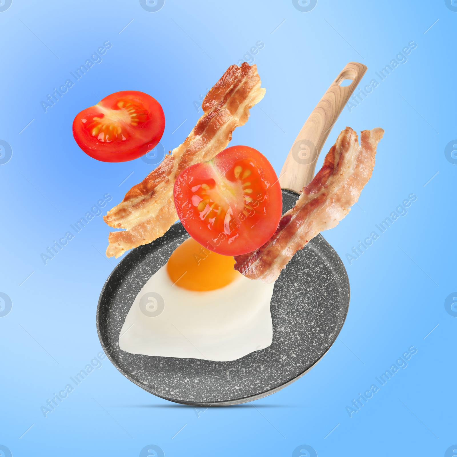 Image of Tasty fried chicken egg, bacon and tomato falling into frying pan on light blue background