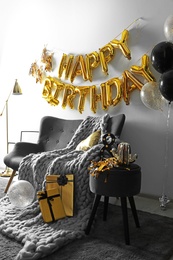 Room decorated for birthday party with different balloons