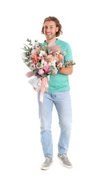 Young handsome man with beautiful flower bouquet on white background