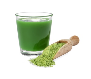 Photo of Glass of wheat grass juice and scoop with powder on white background