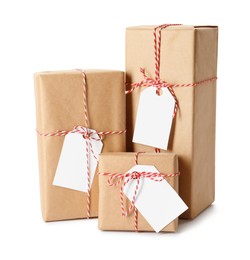 Photo of Gift boxes wrapped in kraft paper with tags on white background