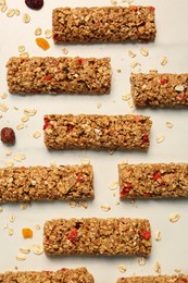 Photo of Tasty granola bars on white table, flat lay