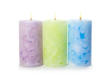 Photo of Alight color wax candles on white background