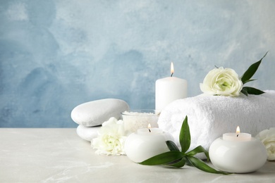 Photo of Beautiful spa composition with candles and flowers on table, space for text