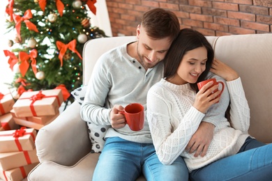 Happy young couple celebrating Christmas at home