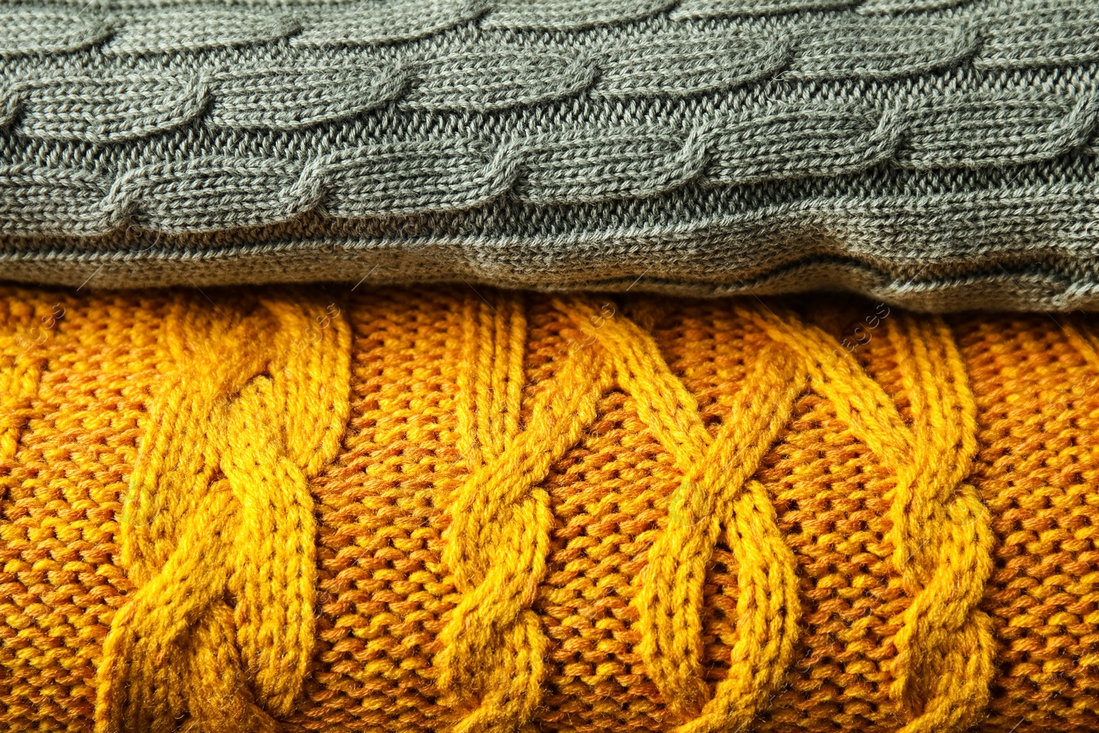 Photo of Stack of soft warm plaids as background, closeup