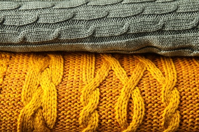 Photo of Stack of soft warm plaids as background, closeup