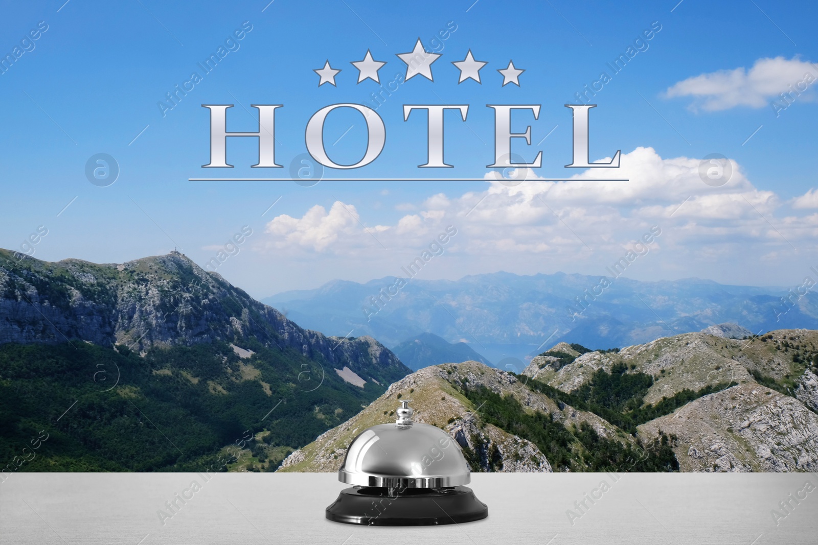 Image of 5 Star hotel. Reception desk with service bell and picturesque landscape on background