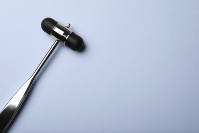 Photo of Reflex hammer on grey background, top view with space for text. Nervous system diagnostic