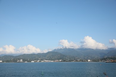 Picturesque view of city near sea and mountains