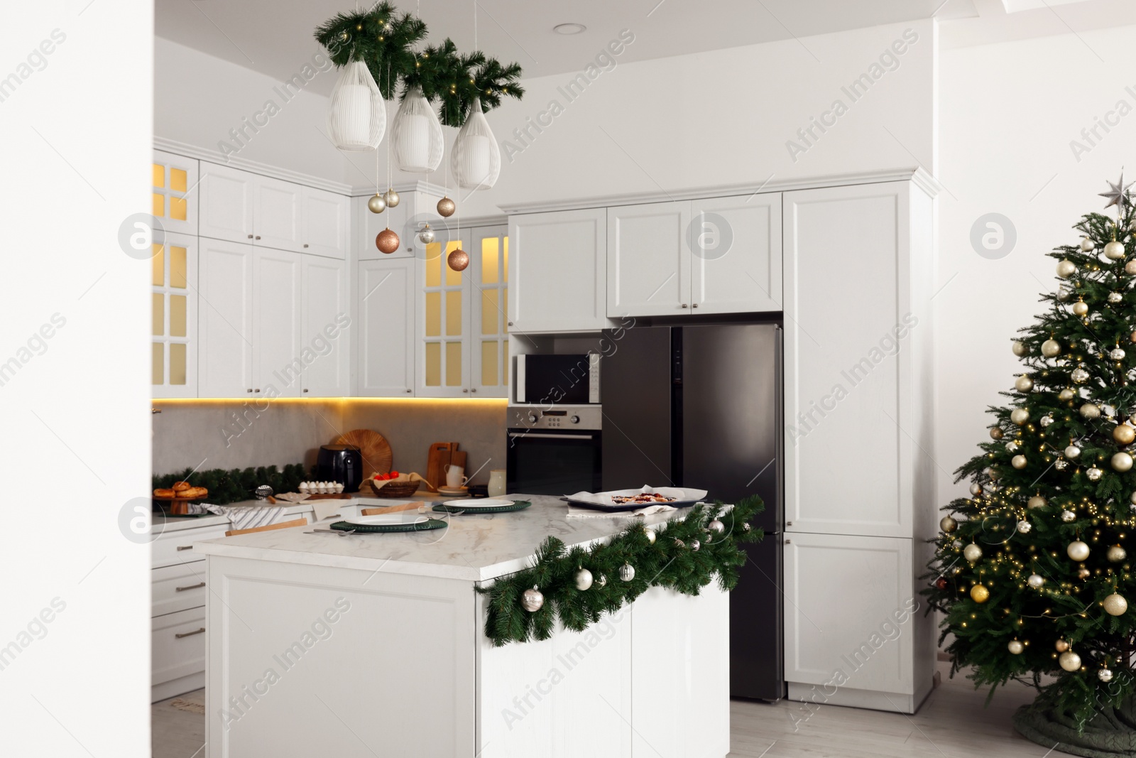 Photo of Cozy spacious kitchen decorated for Christmas. Interior design